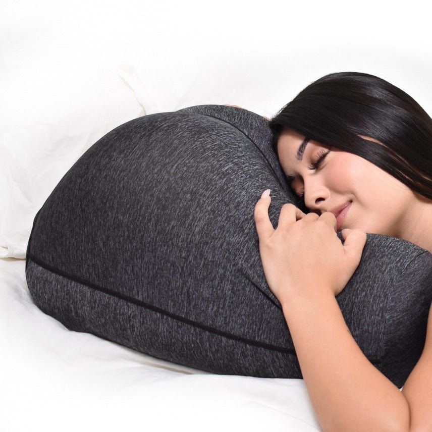 Stomach sleeper position with Buttress Pillow - showing breathing gap between thighs for comfortable face-down sleeping